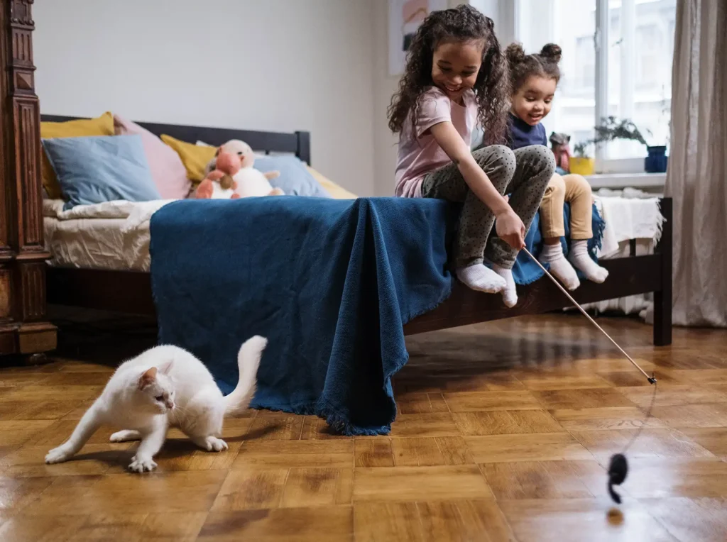 Children playing with an energetic cat